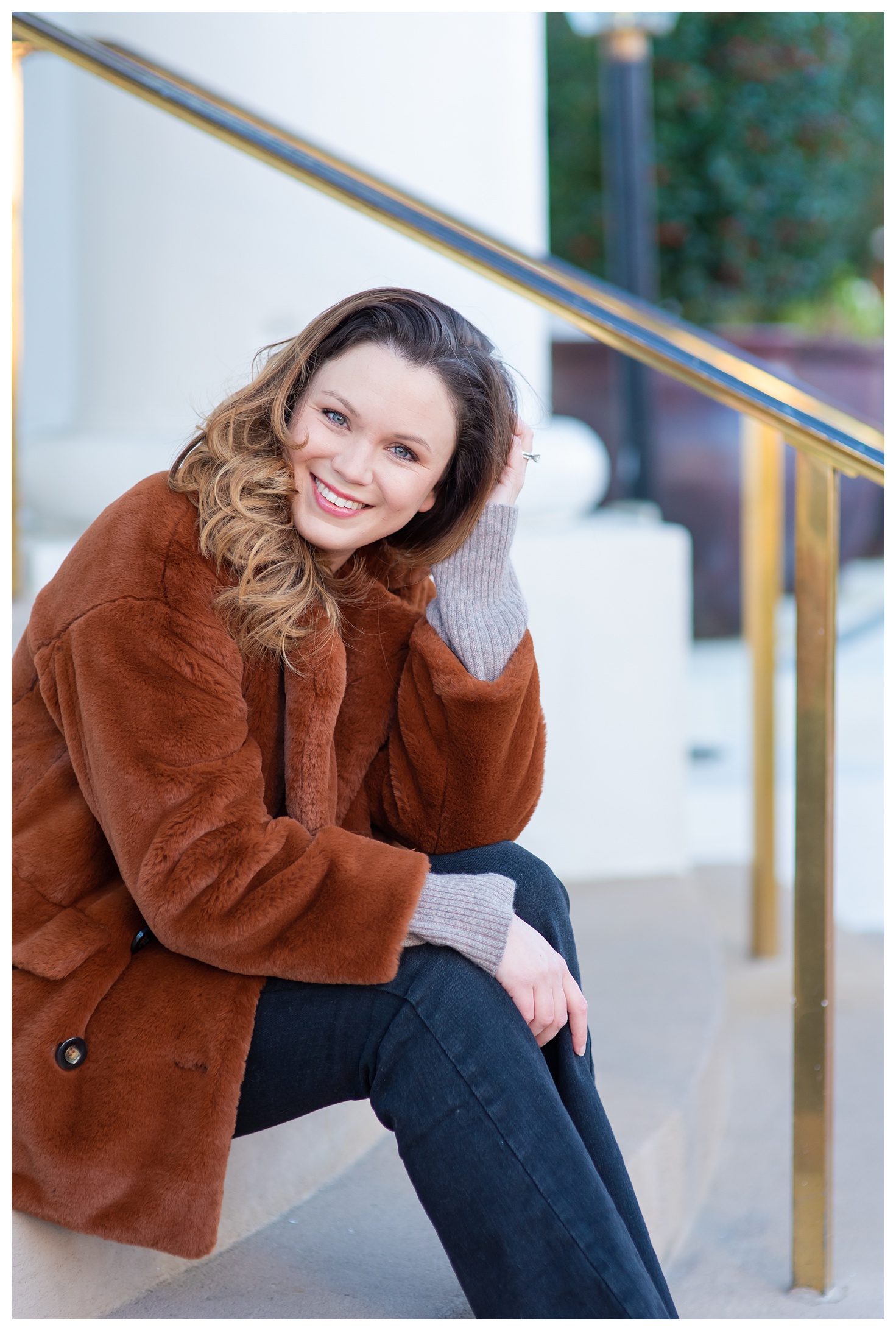 woman wearing furry coat leaning and smiling